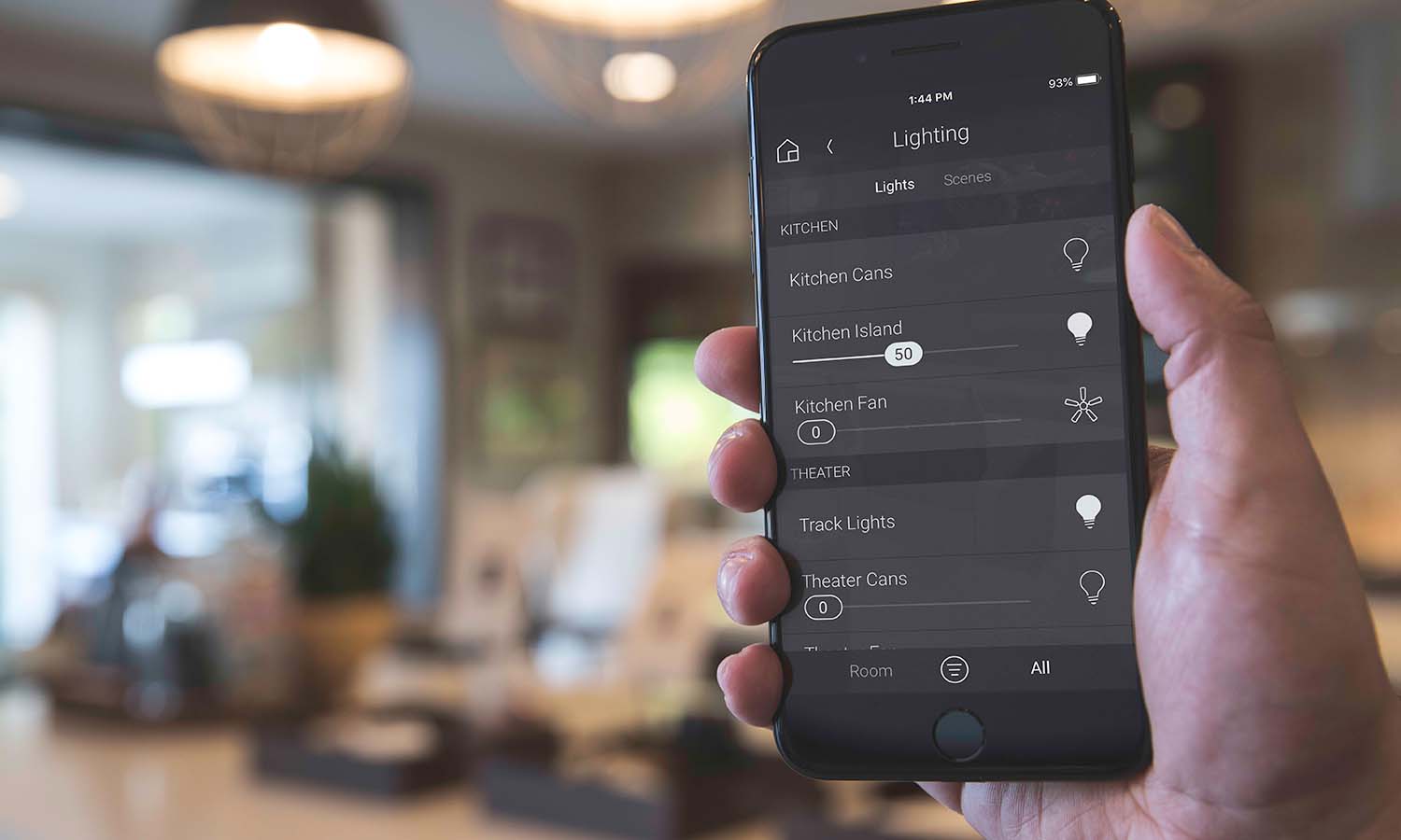 Person holding iphone with Control4 interface on it