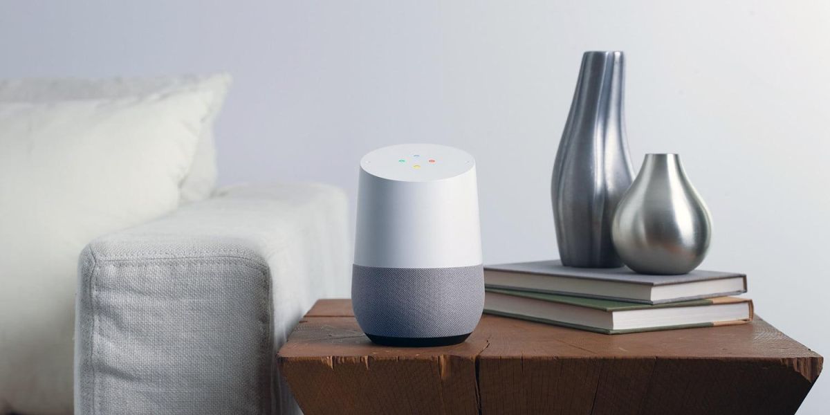 google speaker on side table next to white couch