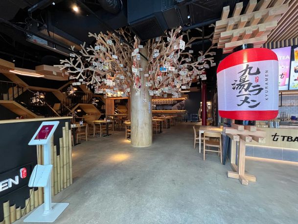 Japanese restaurant interior showing wood architecture tree feature and giant paper lantern